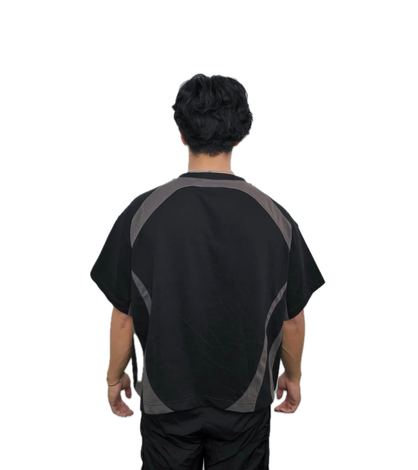Person wearing a black and gray shirt on a white background